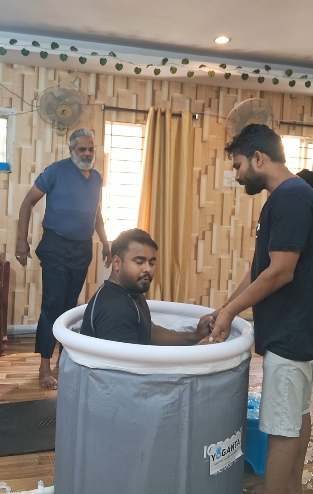 Goutham Singh in a Yoganta ice bath tub with a trainer beside him at the Yoganta Ice Bath Instructor Course (YCIBI) workshop in Hyderabad.
