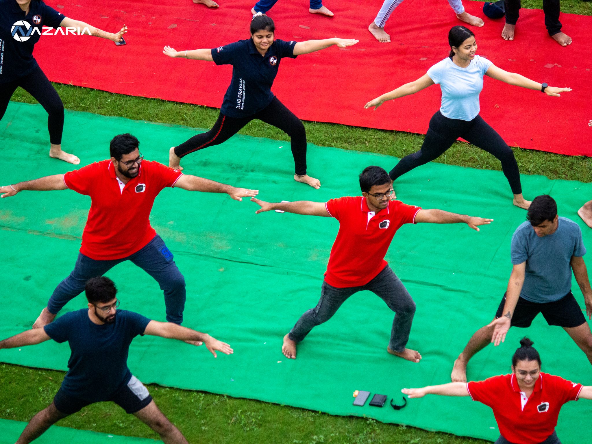 Participants practicing Virabhadrasana (Warrior Pose) together during a Yoganta outdoor group yoga session.