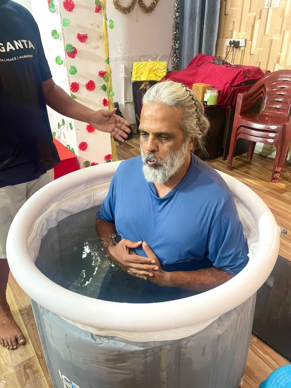 Close-up of Hari Subramanyam seated in a Yoganta ice bath tub at the Yoganta Ice Bath Instructor Course (YCIBI) workshop in Hyderabad.