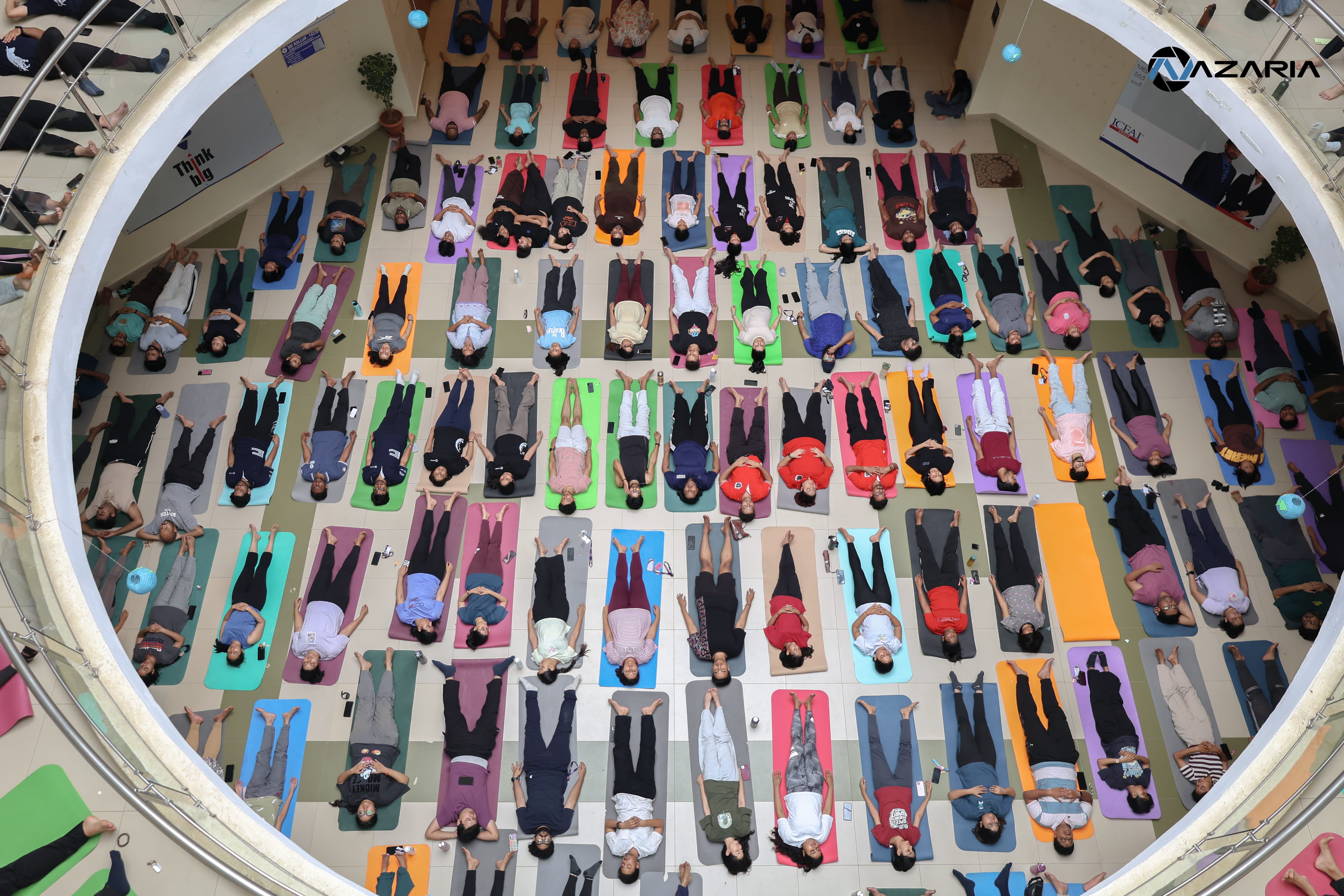 Aerial view of participants practicing Savasana during a Yoganta yoga event.