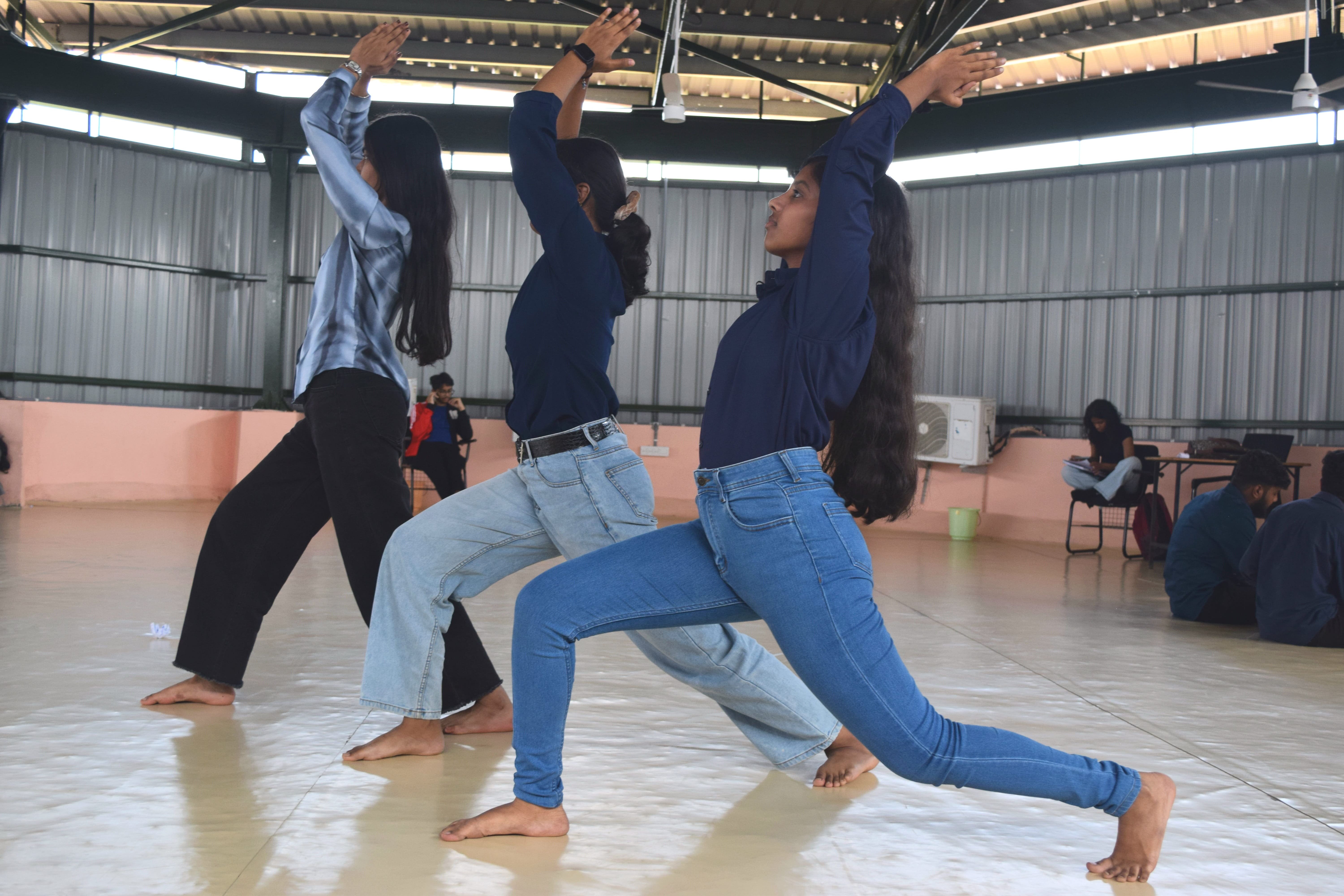 Participants practicing Virabhadrasana during a Yoganta yoga class.