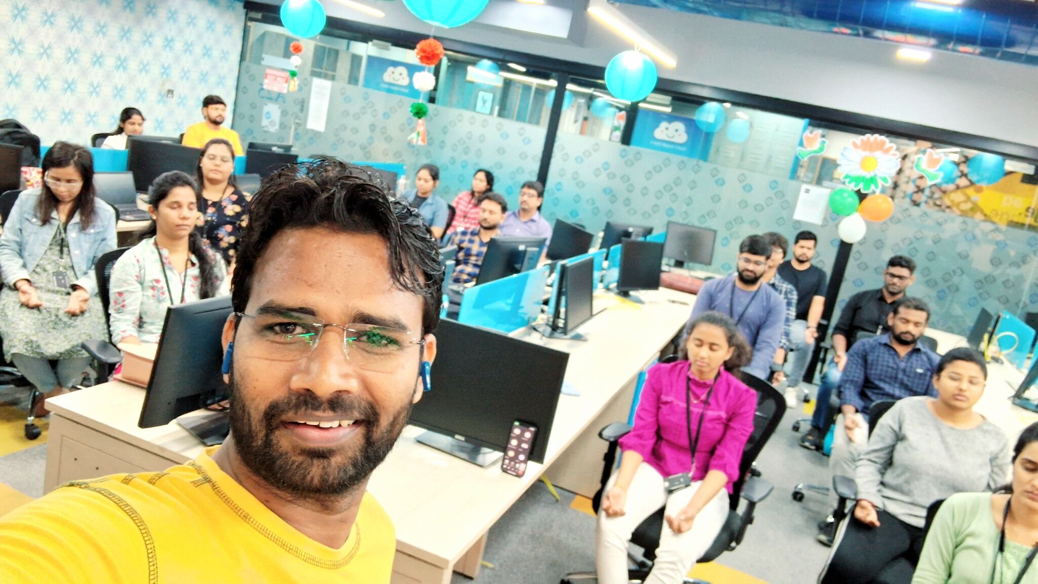 Raushan Yoganta conducting a corporate yoga session at IQVIA with employees participating in a workplace wellness program.